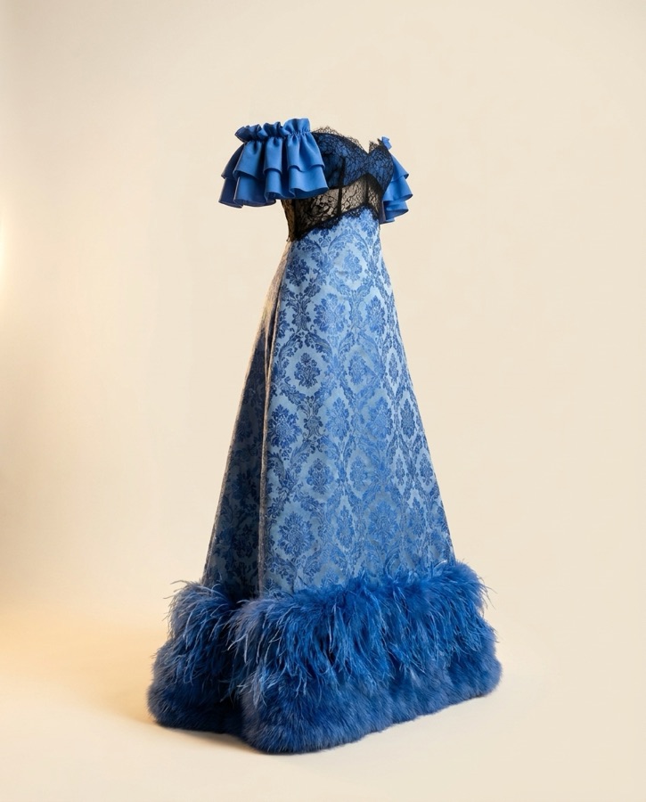 Caliente by Oscar B — blue sequin gown with feather trim